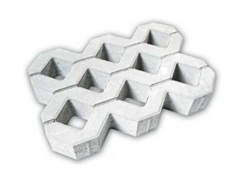 Pavé alvéolé en béton clair, ajouré d’alvéoles